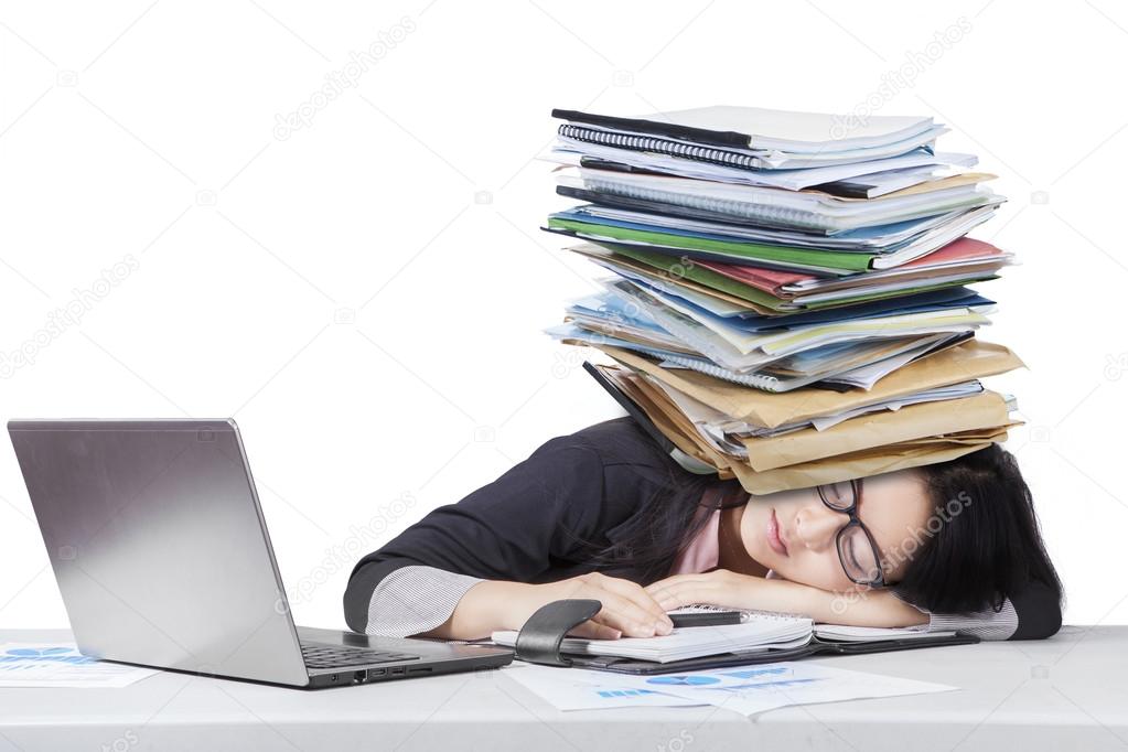 Tired businesswoman sleeping with paperwork
