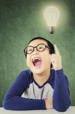 Adorable schoolboy find an idea