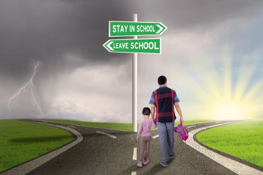 Dad and child walking on the road to school