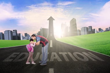 Father kiss his child on the road with arrow