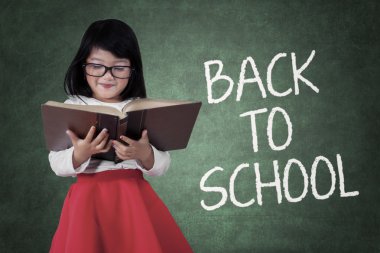 Girl studying with a text of back to school