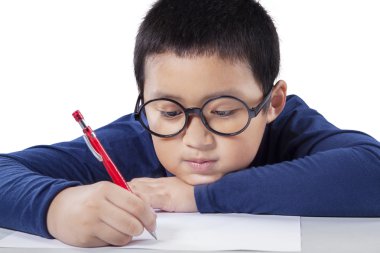 Little boy writing on the paper