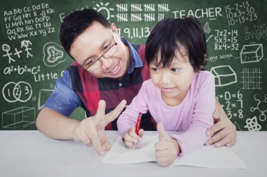 Male teacher teach his student to calculate