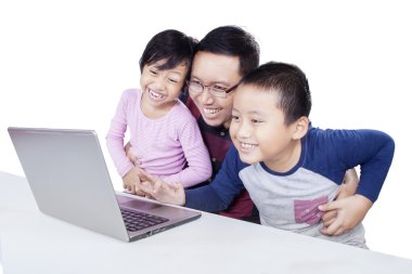 Man and his children having fun with laptop