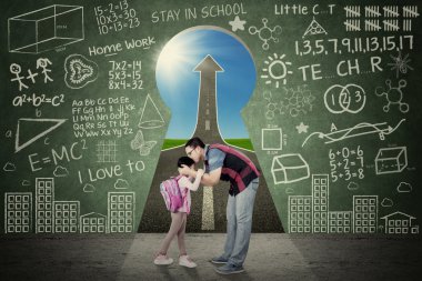 Man kiss his kid in front of a key hole