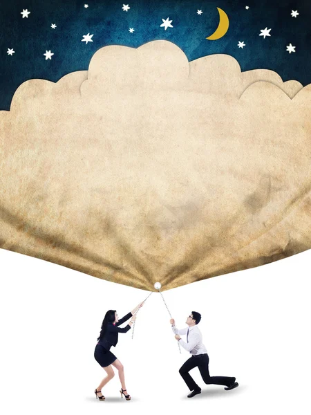 Businesspeople pull a flag with stars and moon — Stock Photo, Image