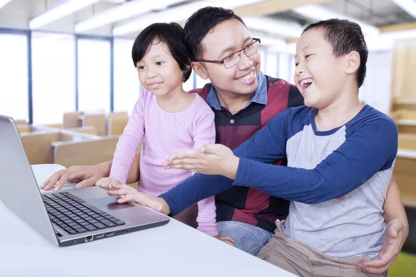 Friendly teacher talking with his students in the class — 图库照片