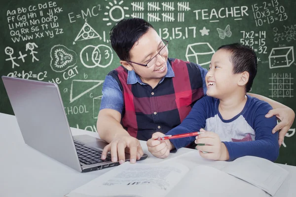 Male student talking with his tutor in the class — Stock Fotó