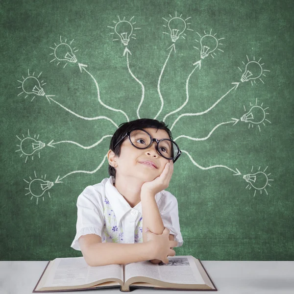 Primary school student with branchy light bulb — Stock Photo, Image