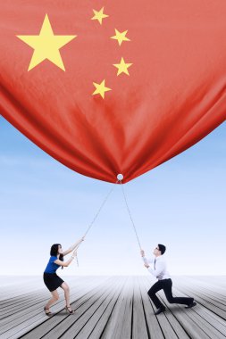 Entrepreneurs pulling down a chinese flag