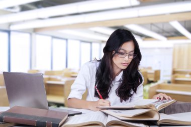 Student doing school assignment in the class