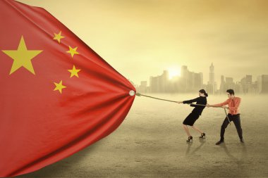 Two workers pulling a chinese flag