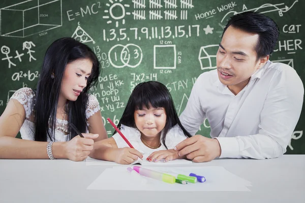 Studente che studia in classe con due insegnanti — Foto Stock