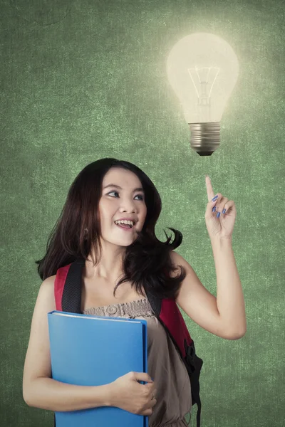 Teenage student with light bulb get an idea — ストック写真