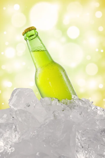 Dewy beverage in the bottle with ice cube — Stock Photo, Image