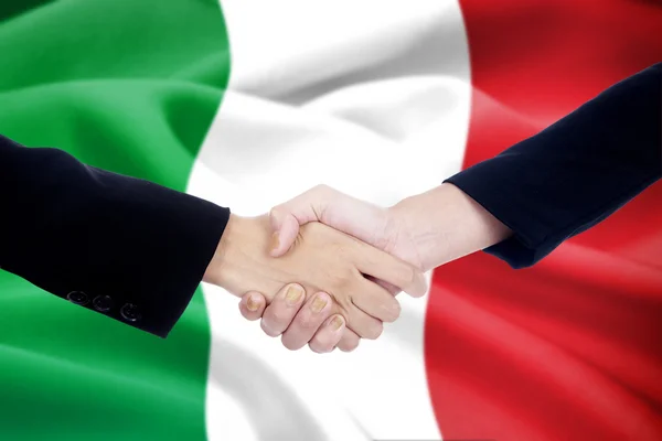 Handslag med Italien flagga bakgrund — Stockfoto