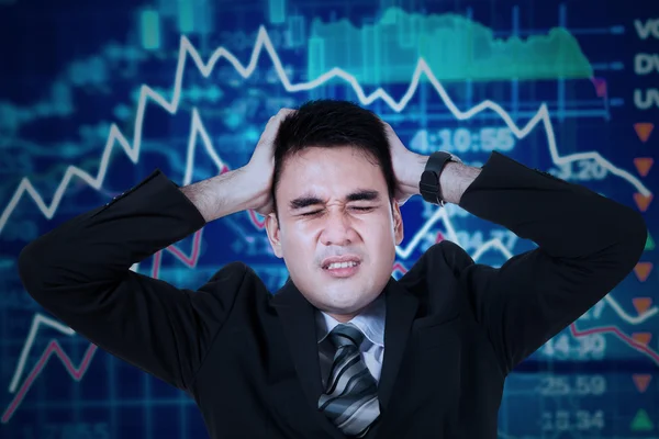 Stressful businessman with stock exchange background — Stock Photo, Image