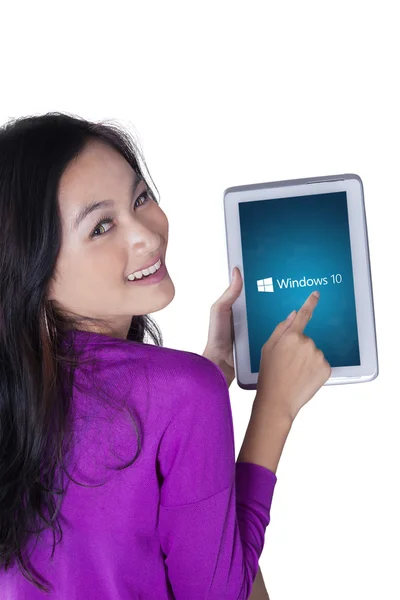 Asian girl holds tablet with windows 10 — Stok fotoğraf