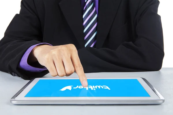 Businessman touching twitter symbol on tablet — Stock Photo, Image
