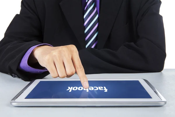 Businessperson with facebook logo on tablet — Stock Photo, Image