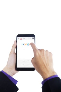 Hand touching google logo on cellphone