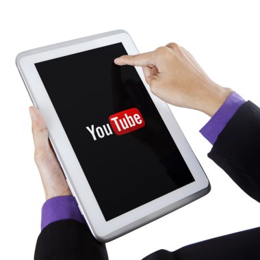 Hand touching tablet screen with youtube symbol