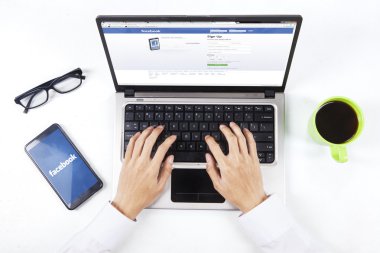 Person open facebook website with laptop