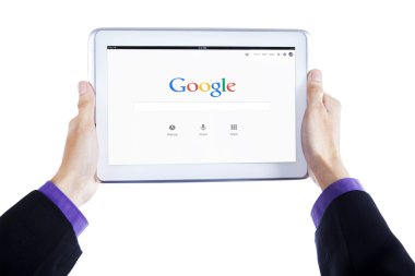 Worker hands hold tablet with google homepage