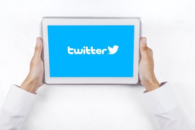 Worker hands showing twitter logo with tablet