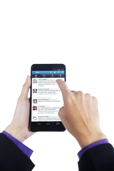 Finger touching news on twitter with cellphone — Stok fotoğraf