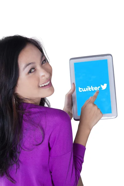 Girl holding a tablet with twitter logo — Stock Fotó