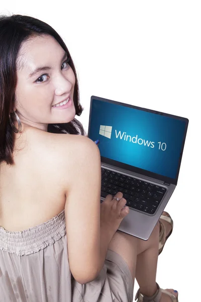 Teenage girl using laptop with windows 10 — стокове фото