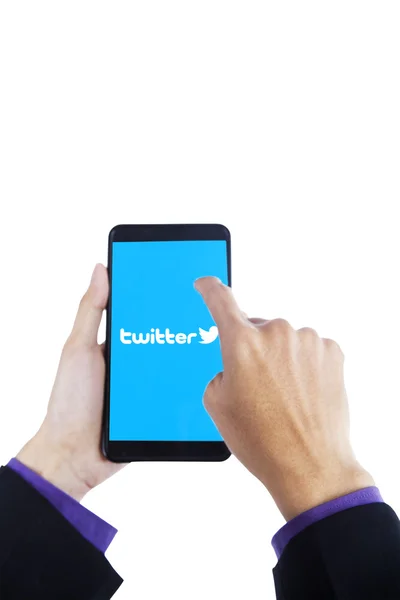 Worker hand touching twitter symbol on cellphone — Stock Photo, Image