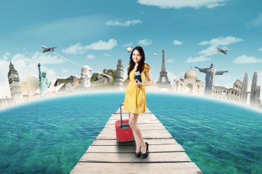 Beautiful tourist holds passport on the bridge