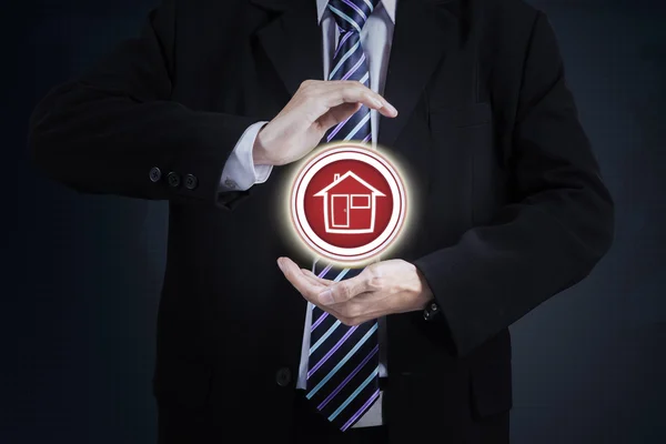Businessperson protecting house icon — Stock Photo, Image