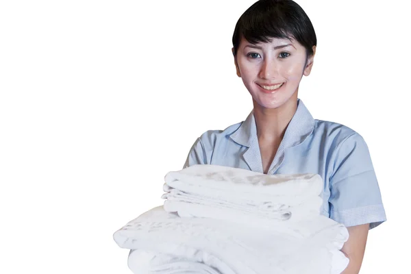 Asian female cleaner holding sheets on white — Stockfoto