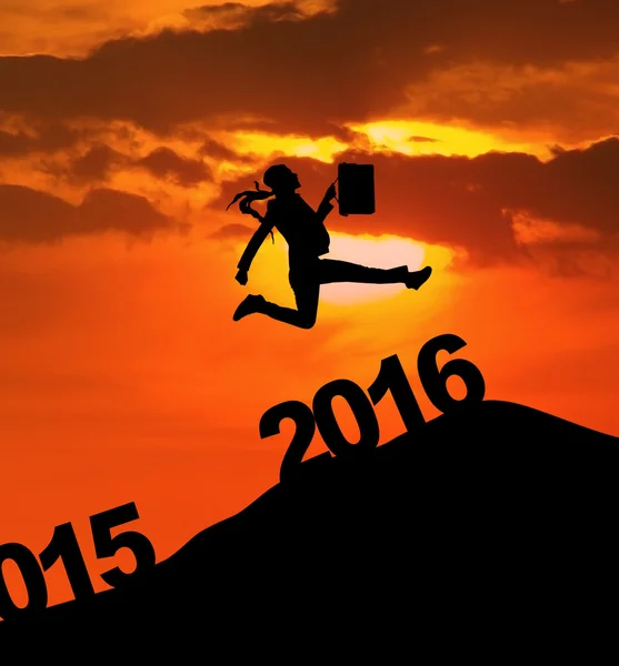 Businesswoman jumping over 2016 numbers — ストック写真