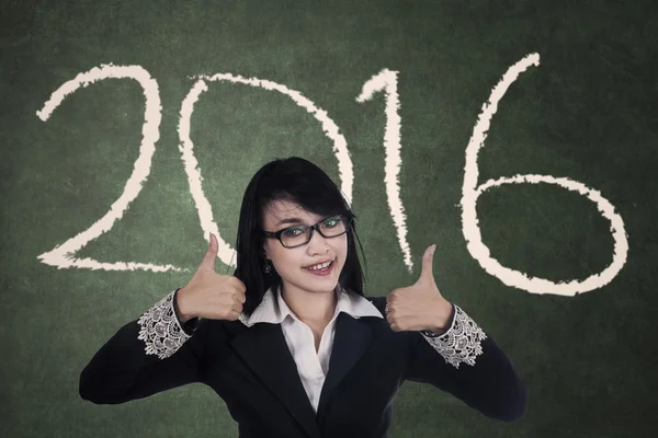 Woman showing thumbs up with numbers 2016 — Stock Photo, Image
