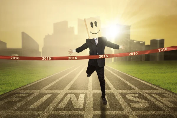 Businessperson crossing the finish line — Stock Photo, Image