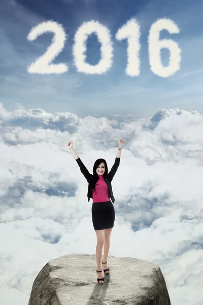 Happy woman standing on the cliff with numbers 2016 — Stock Photo, Image