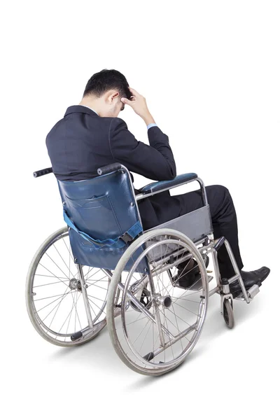 Stressful man sitting on the wheelchair — Stock Photo, Image