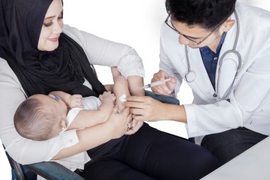 Image of doctor injecting vaccine on the baby clipart