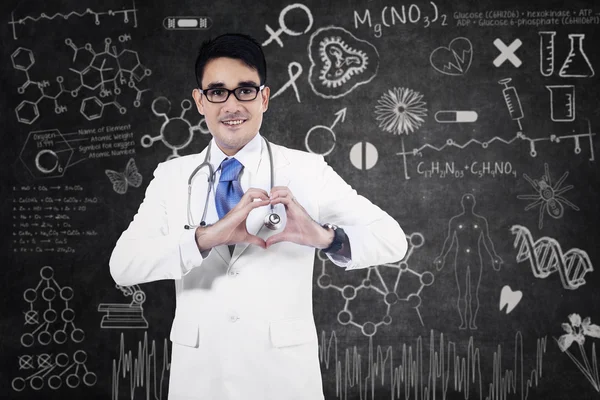 Medical doctor showing heart shape — Stock Photo, Image