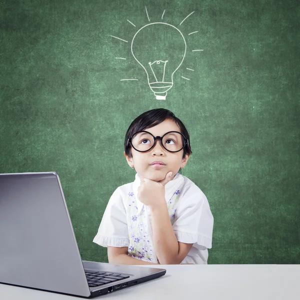 Pensive kindergarten student with laptop — Stock Photo, Image