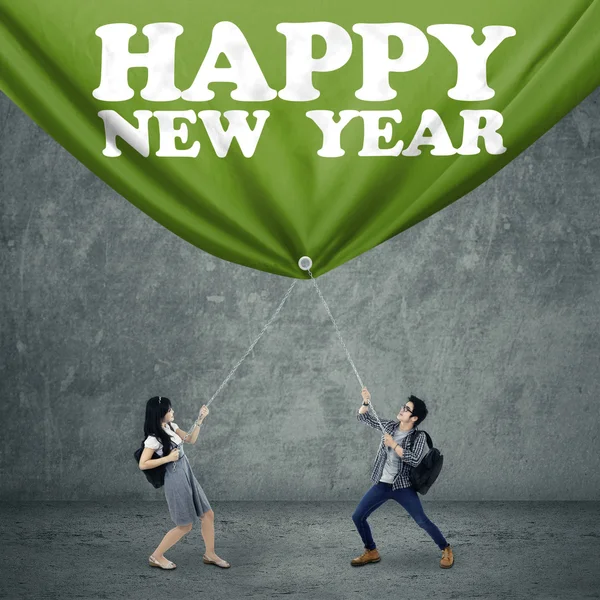 Students and new year banner — Stock Photo, Image