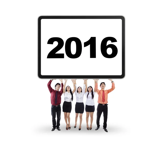 Business team holding a board with numbers 2016 — Stock Photo, Image