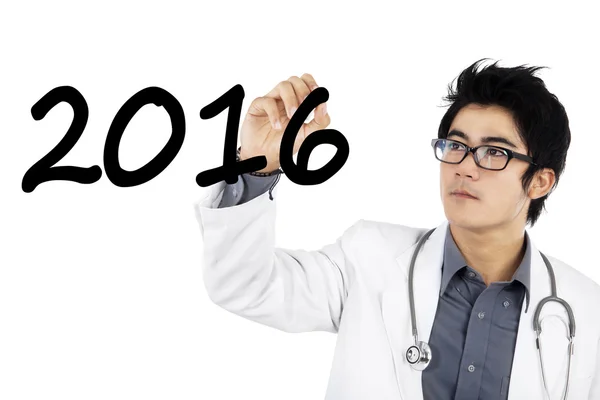 Médico masculino escribe números 2016 —  Fotos de Stock