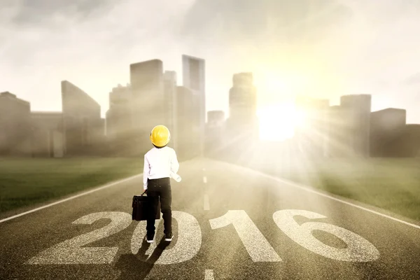 Little boy on the road with numbers 2016 — Stock Photo, Image