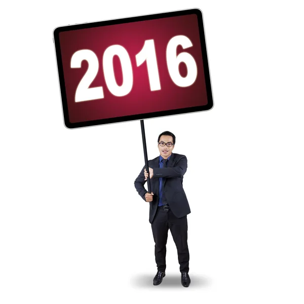 Male worker holding placard with numbers 2016 — Stockfoto