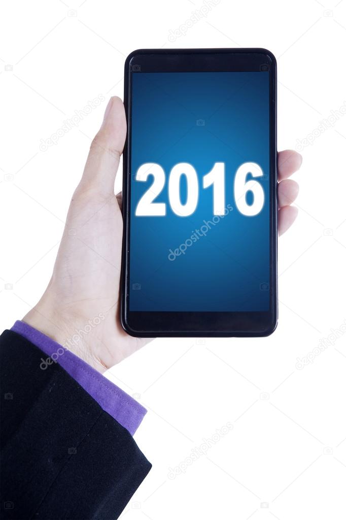 Businessperson hand holds cellphone with numbers 2016